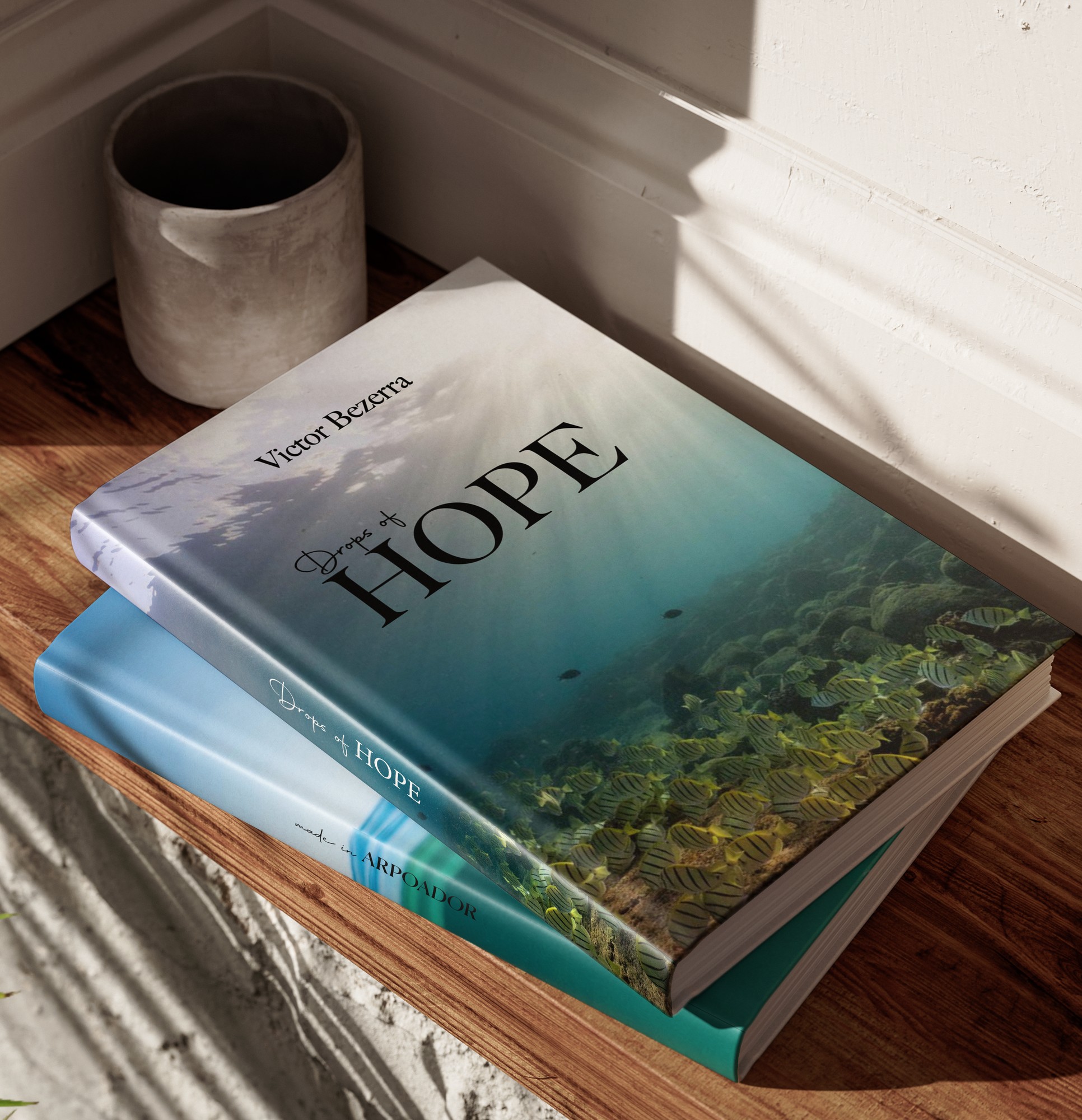 Two hardcover copies of Drops of Hope in natural light
